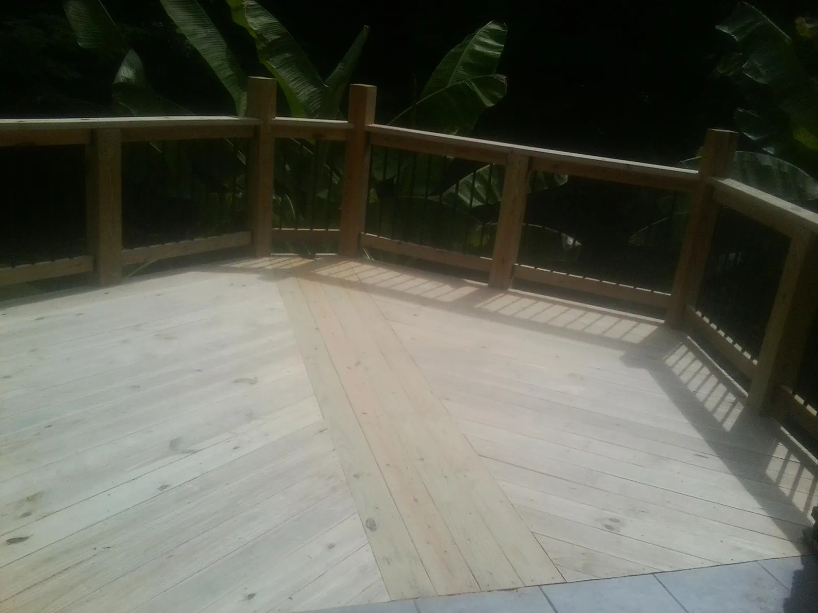 New wood deck and railing built off the back of a home in Jasper